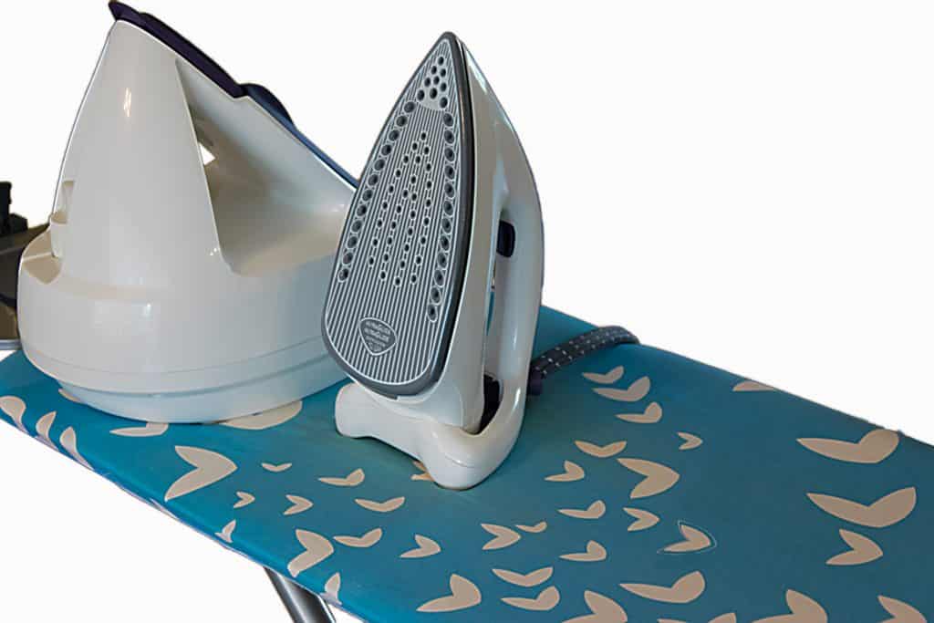 Steam iron resting on an ironing board